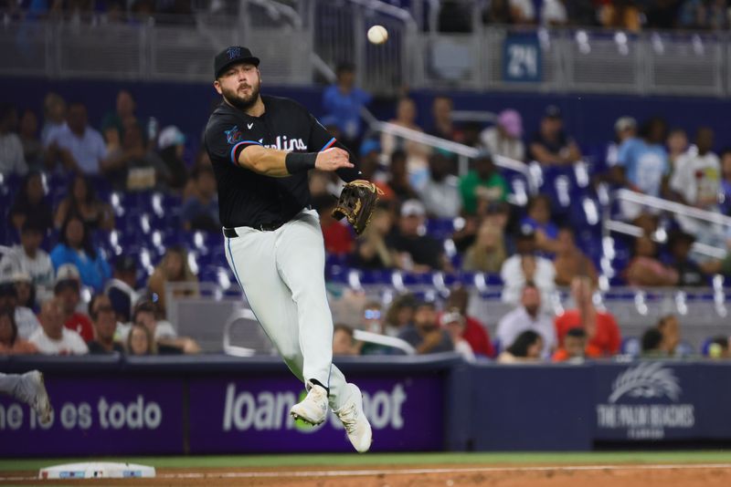 Jul 5, 2024; Miami, Florida, USA; Miami Marlins third baseman Jake Burger (36) throws to first base to retire Chicago White Sox designated hitter Eloy Jimenez (not pictured) during the third inning at loanDepot Park. Mandatory Credit: Sam Navarro-USA TODAY Sports