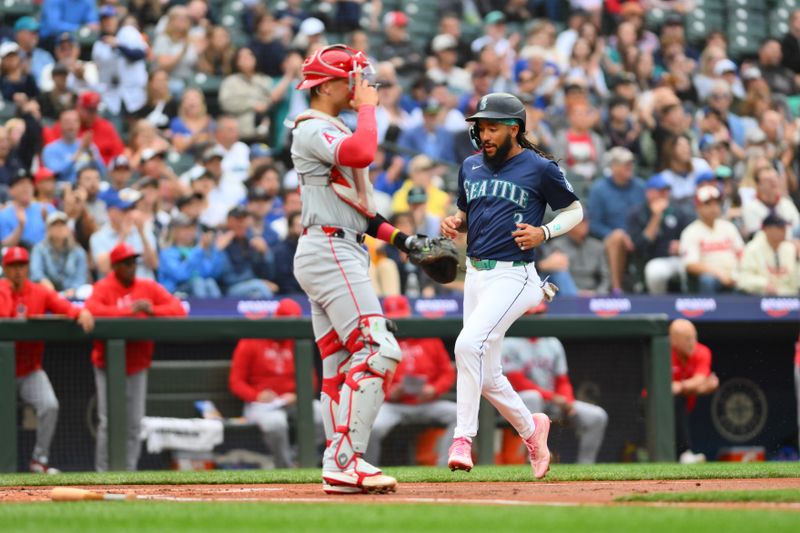 Jul 22, 2024; Seattle, Washington, USA; Seattle Mariners shortstop J.P. Crawford (3) scores a run against the Los Angeles Angels during the first inning at T-Mobile Park. Mandatory Credit: Steven Bisig-USA TODAY Sports