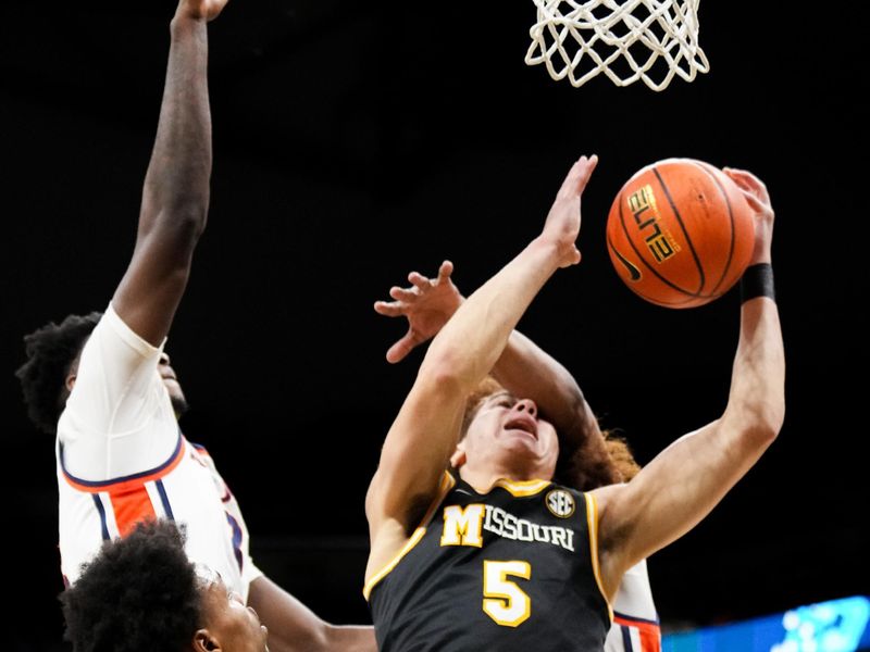 Jan 14, 2026; Columbia, Missouri, USA; Missouri Tigers guard T.O. Barrett (5) is fouled while shooting against the Auburn Tigers during the first half of the game at Mizzou Arena. Mandatory Credit: Denny Medley-Imagn Images