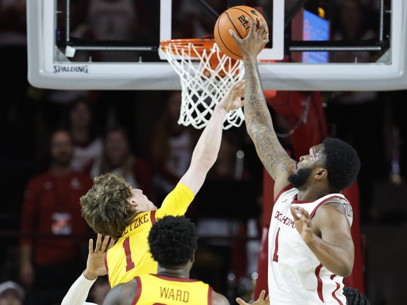 Jan 6, 2024; Norman, Oklahoma, USA; Oklahoma Sooners forward John Hugley IV (1) blocks a shot by Iowa State Cyclones guard Jackson Paveletzke (1) during the second half at Lloyd Noble Center. Mandatory Credit: Alonzo Adams-USA TODAY Sports