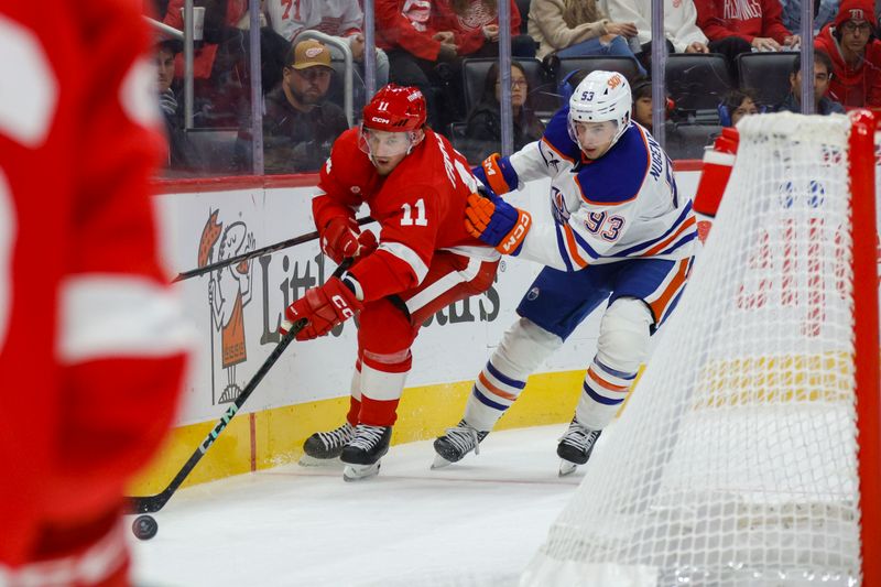 Oct 27, 2024; Detroit, Michigan, USA; Detroit Red Wings right wing Vladimir Tarasenko (11) handles the puck against Edmonton Oilers center Ryan Nugent-Hopkins (93) during the third period at Little Caesars Arena. Mandatory Credit: Brian Bradshaw Sevald-Imagn Images