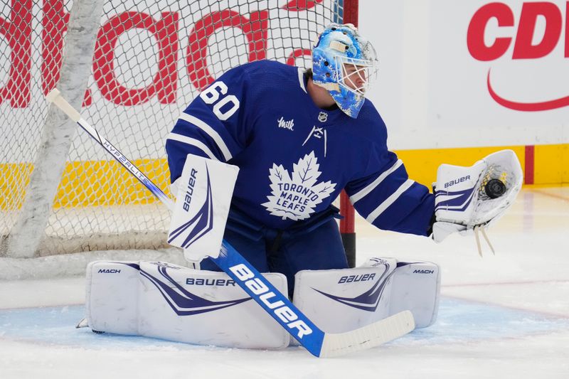 Feb 29, 2024; Toronto, Ontario, CAN; Toronto Maple Leafs goaltender Joseph Woll (60) makes a save during warm up before a game against the Arizona Coyotes at Scotiabank Arena. Mandatory Credit: John E. Sokolowski-USA TODAY Sports