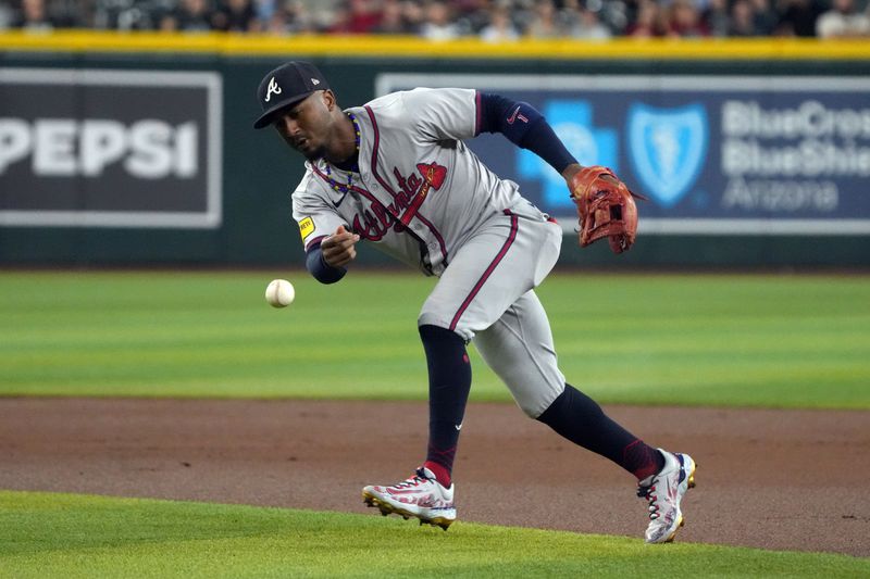 Jul 11, 2024; Phoenix, Arizona, USA; Atlanta Braves second base Ozzie Albies (1) drops a grounder in the first inning against the Arizona Diamondbacks at Chase Field. Mandatory Credit: Rick Scuteri-USA TODAY Sports