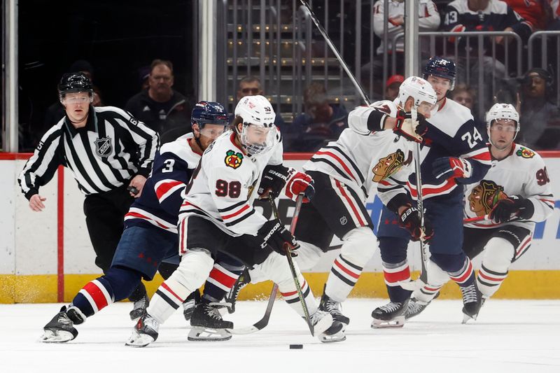 Mar 9, 2024; Washington, District of Columbia, USA; Chicago Blackhawks center Connor Bedard (98) skates with the puck as Washington Capitals defenseman Nick Jensen (3) defends in the third period at Capital One Arena. Mandatory Credit: Geoff Burke-USA TODAY Sports