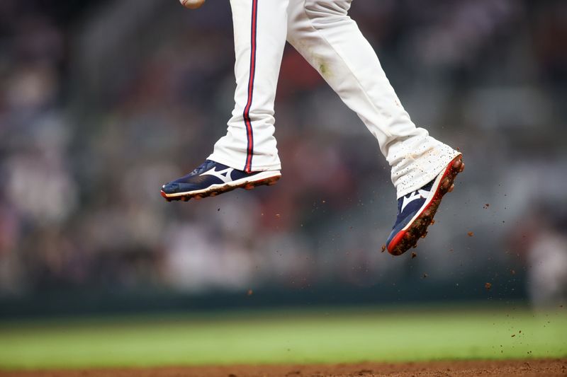 Apr 24, 2024; Atlanta, Georgia, USA; A detailed view of Atlanta Braves third baseman Austin Riley (27) jumping for a ball against the Miami Marlins in the tenth inning at Truist Park. Mandatory Credit: Brett Davis-USA TODAY Sports