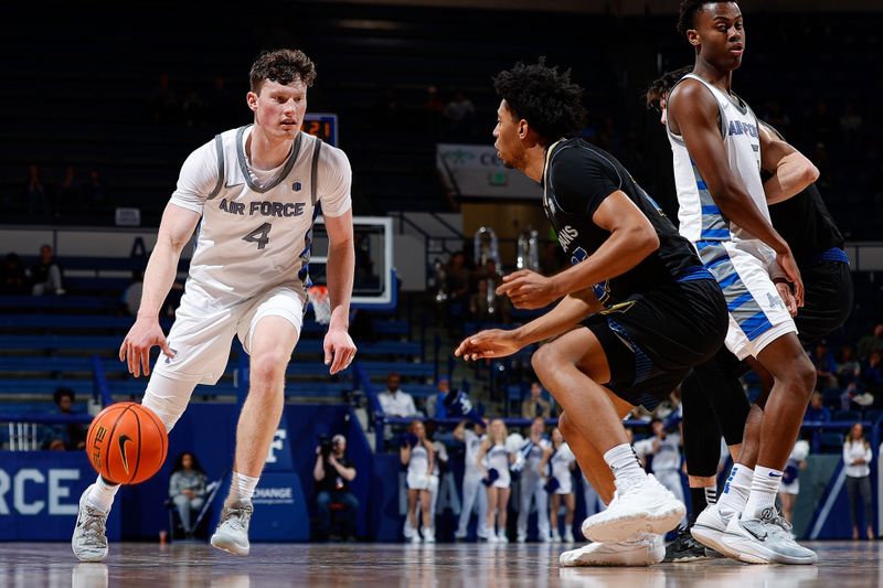 Mar 4, 2023; Colorado Springs, Colorado, USA; Air Force Falcons guard Carter Murphy (4) controls the ball against San Jose State Spartans guard Ryen Perry (25) as guard Ethan Taylor (5) defends in the second half at Clune Arena. Mandatory Credit: Isaiah J. Downing-USA TODAY Sports