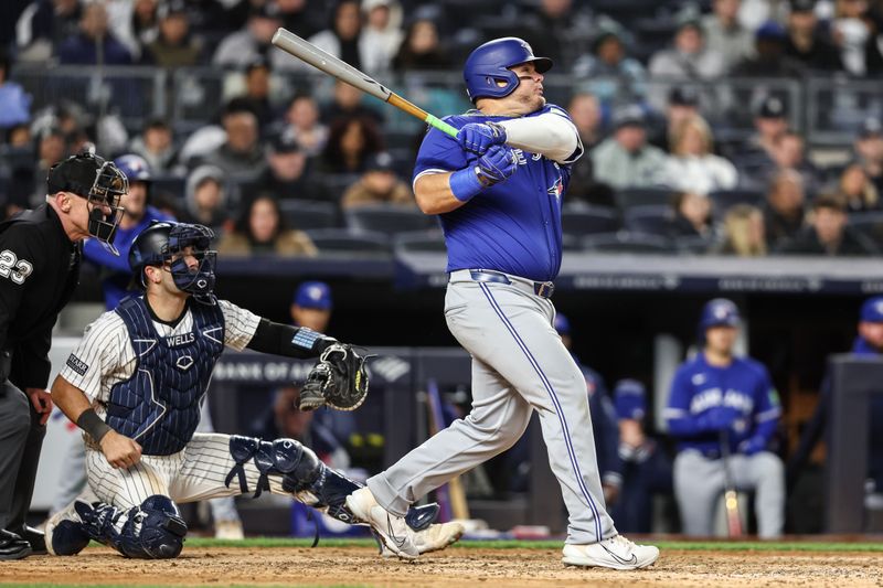 Apr 6, 2024; Bronx, New York, USA; Toronto Blue Jays designated hitter Daniel Vogelbach (20) hits an RBI double in the seventh inning against the New York Yankees at Yankee Stadium. Mandatory Credit: Wendell Cruz-USA TODAY Sports