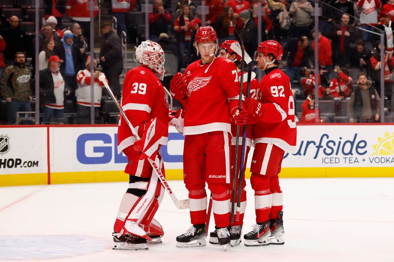 Nov 18, 2025; Detroit, Michigan, USA; Detroit Red Wings  goaltender Cam Talbot (39)  defenseman Simon Edvinsson (77) and center Marco Kasper (92) celebrate defeating the Seattle Kraken at Little Caesars Arena. Mandatory Credit: Rick Osentoski-Imagn Images