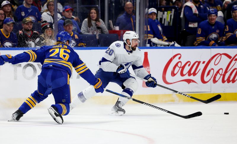 Jan 20, 2024; Buffalo, New York, USA;  Tampa Bay Lightning left wing Nicholas Paul (20) makes a pass as Buffalo Sabres defenseman Rasmus Dahlin (26) defends during the first period at KeyBank Center. Mandatory Credit: Timothy T. Ludwig-USA TODAY Sports