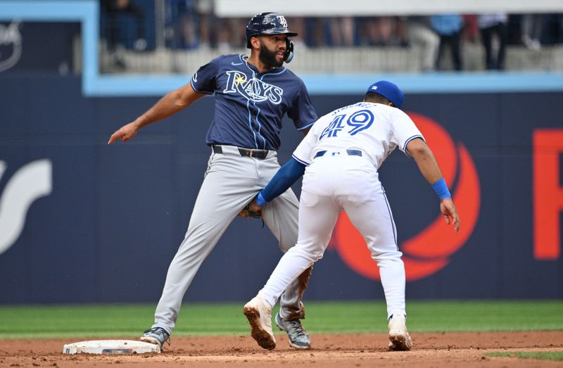 Jul 25, 2024; Toronto, Ontario, CAN;  Tampa Bay Rays third baseman Ahmed Rosario (10) steals second base against Toronto Blue Jays shortstop Leo Jimenez (45) in the second inning at Rogers Centre. Mandatory Credit: Dan Hamilton-USA TODAY Sports