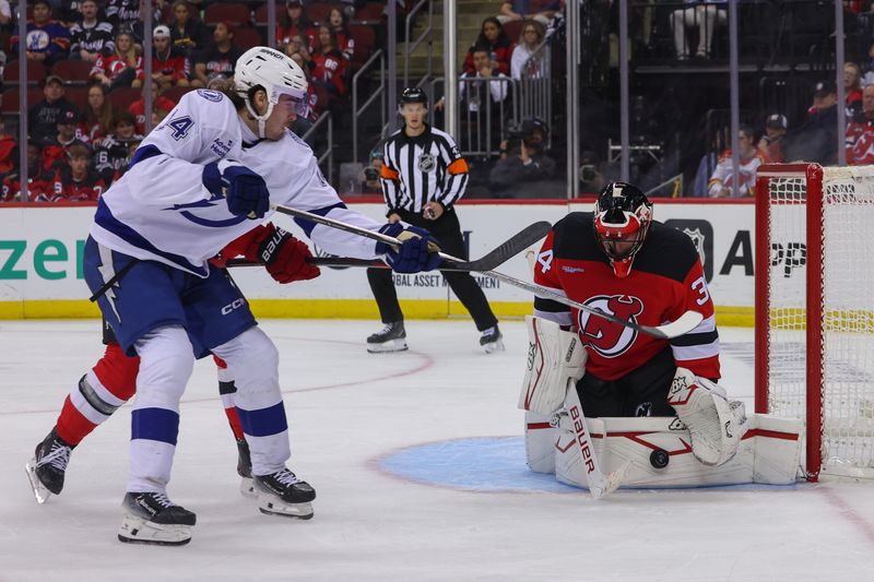 Oct 22, 2024; Newark, New Jersey, USA; New Jersey Devils goaltender Jake Allen (34) makes a save against the Tampa Bay Lightning during the third period at Prudential Center. Mandatory Credit: Ed Mulholland-Imagn Images