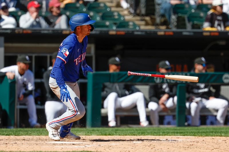 May 25, 2025; Chicago, Illinois, USA; Texas Rangers catcher Kyle Higashioka (11) hits an RBI-single against the Chicago White Sox during the ninth inning at Rate Field. Mandatory Credit: Kamil Krzaczynski-Imagn Images