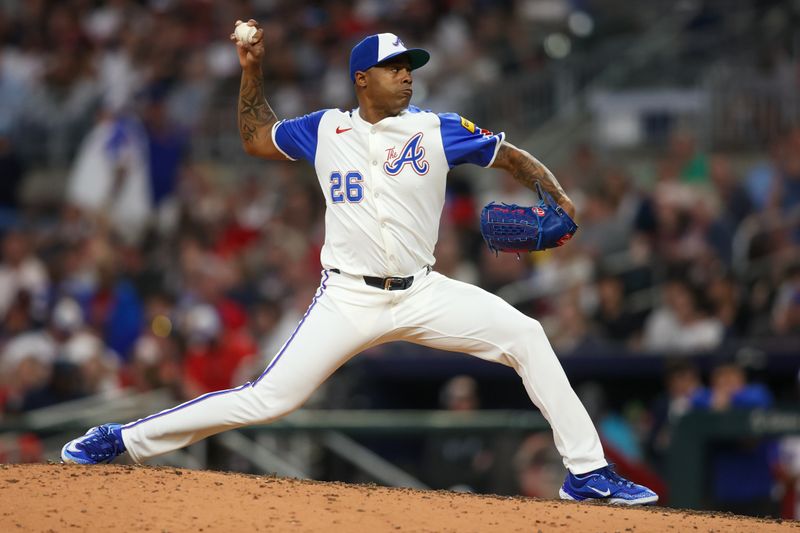 Apr 27, 2024; Atlanta, Georgia, USA; Atlanta Braves relief pitcher Raisel Iglesias (26) throws against the Cleveland Guardians in the ninth inning at Truist Park. Mandatory Credit: Brett Davis-USA TODAY Sports
