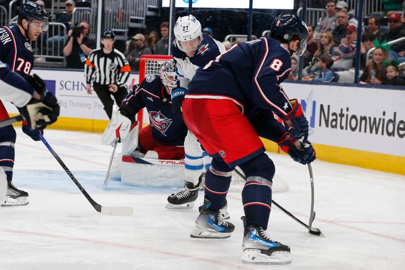 Mar 17, 2024; Columbus, Ohio, USA; Columbus Blue Jackets defenseman Zach Werenski (8) knocks the puck away from Winnipeg Jets left wing Nikolaj Ehlers (27) during the third period at Nationwide Arena. Mandatory Credit: Russell LaBounty-USA TODAY Sports