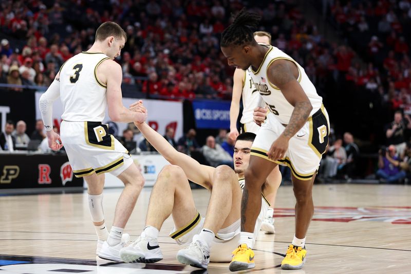 Mar 16, 2024; Minneapolis, MN, USA; Purdue Boilermakers center Zach Edey (15) is helped up off the court during the first half against the Wisconsin Badgers at Target Center. Mandatory Credit: Matt Krohn-USA TODAY Sports