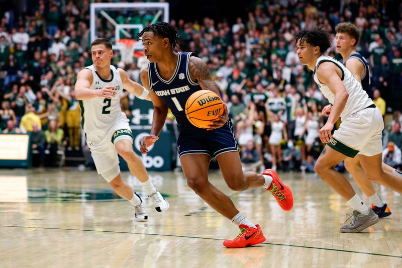 Jan 23, 2026; Fort Collins, Colorado, USA; Utah State Aggies guard Elijah Perryman (1) controls the ball in the first half against the Colorado State Rams at Moby Arena. Mandatory Credit: Isaiah J. Downing-Imagn Images