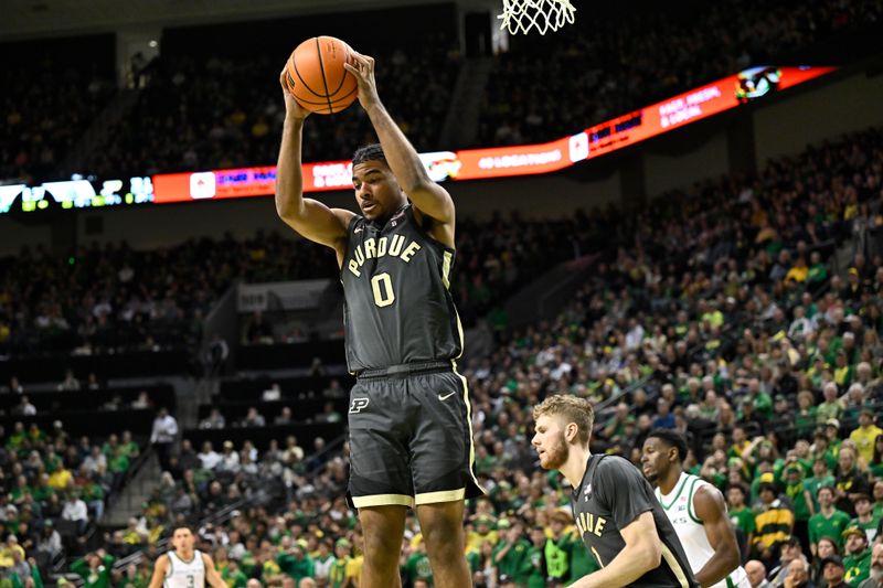 Jan 18, 2025; Eugene, Oregon, USA; Purdue Boilermakers guard C.J. Cox (0) grabs a rebound against the Oregon Ducks during the first half at Matthew Knight Arena. Mandatory Credit: Craig Strobeck-Imagn Images
