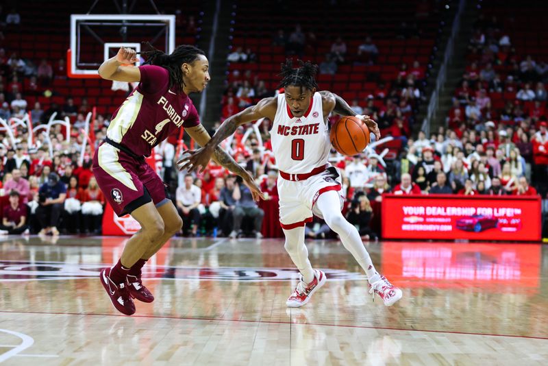 Feb 1, 2023; Raleigh, North Carolina, USA; North Carolina State Wolfpack guard Terquavion Smith (0) dribbles the ball past Florida State Seminoles guard Caleb Mills (4) during the first half at PNC Arena.  Mandatory Credit: Jaylynn Nash-USA TODAY Sports