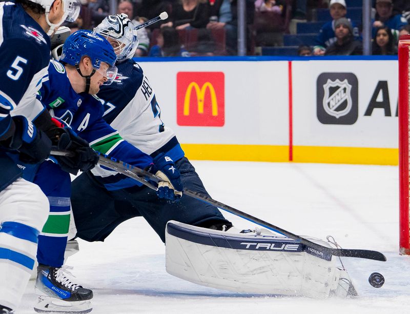 Mar 9, 2024; Vancouver, British Columbia, CAN; Winnipeg Jets defenseman Dylan DeMelo (2) and defenseman Brenden Dillon (5) watch as Vancouver Canucks forward Elias Pettersson (40) scores on goalie Connor Hellebuyck (37) in the second period at Rogers Arena. Mandatory Credit: Bob Frid-USA TODAY Sports