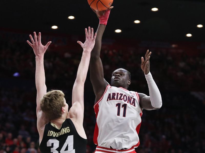 Feb 18, 2023; Tucson, Arizona, USA; Arizona Wildcats center Oumar Ballo (11) shoots a basket against Colorado Buffaloes center Lawson Lovering (34) during the second half at McKale Center. Mandatory Credit: Zachary BonDurant-USA TODAY Sports