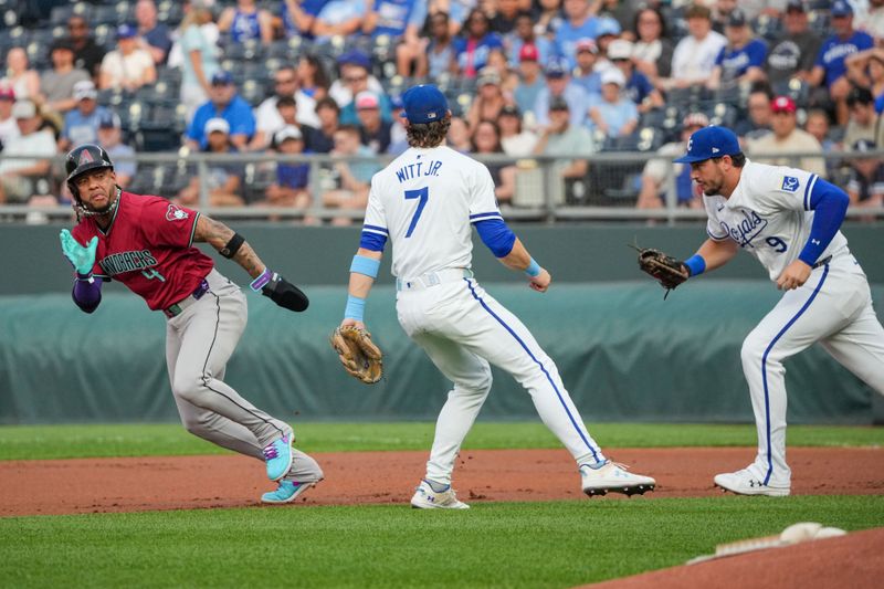 Jul 24, 2024; Kansas City, Missouri, USA; Kansas City Royals first baseman Vinnie Pasquantino (9) chases Arizona Diamondbacks second baseman Ketel Marte (4) in a rundown as shortstop Bobby Witt Jr. (7) looks on in the first inning at Kauffman Stadium. Mandatory Credit: Denny Medley-USA TODAY Sports