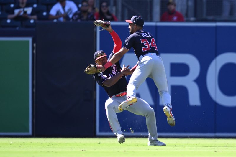 Jun 25, 2023; San Diego, California, USA; Washington Nationals center fielder Derek Hill (34) collides with left fielder Stone Garrett (36) after making a game-ending catch in the ninth inning against the San Diego Padres at Petco Park. Mandatory Credit: Orlando Ramirez-USA TODAY Sports