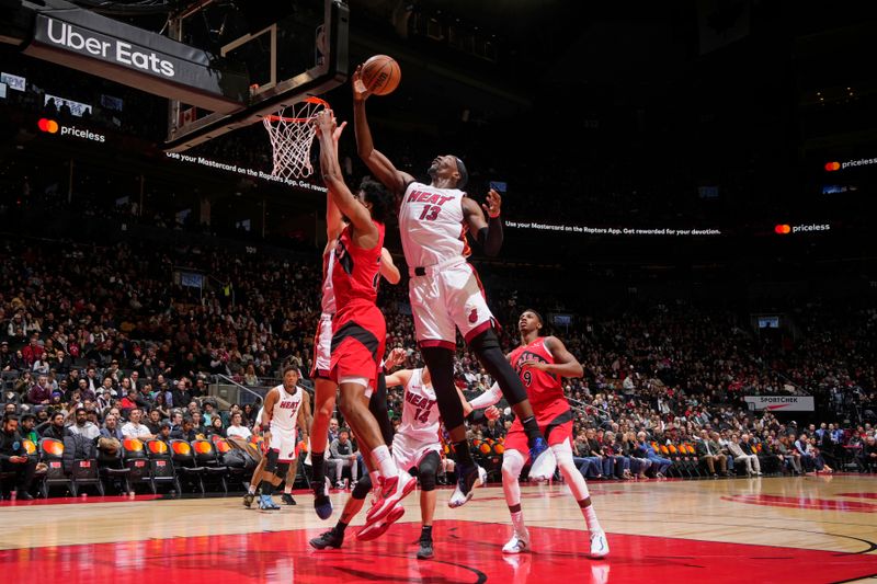 TORONTO, CANADA - JANUARY 17: Bam Adebayo #13 of the Miami Heat rebounds the ball during the game against the Toronto Raptors on January 17, 2024 at the Scotiabank Arena in Toronto, Ontario, Canada.  NOTE TO USER: User expressly acknowledges and agrees that, by downloading and or using this Photograph, user is consenting to the terms and conditions of the Getty Images License Agreement.  Mandatory Copyright Notice: Copyright 2024 NBAE (Photo by Mark Blinch/NBAE via Getty Images)