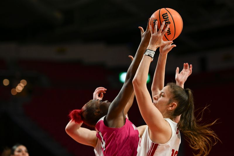 Jan 31, 2024; College Park, Maryland, USA;  Indiana Hoosiers guard Yarden Garzon (12) and Maryland Terrapins guard Bri McDaniel (24) reach for a rebound during the second half at Xfinity Center. Mandatory Credit: Tommy Gilligan-USA TODAY Sports