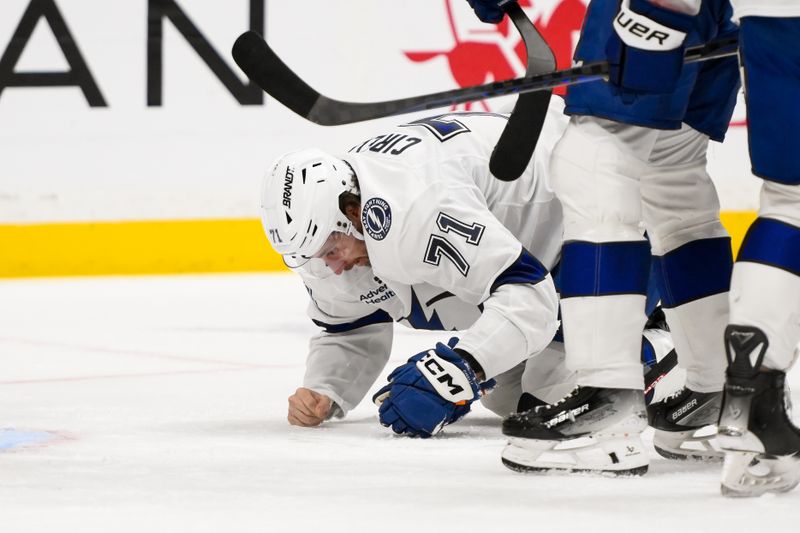 Nov 29, 2024; Nashville, Tennessee, USA;  Tampa Bay Lightning center Anthony Cirelli (71) takes a puck to the face against the Nashville Predators during the first period at Bridgestone Arena. Mandatory Credit: Steve Roberts-Imagn Images