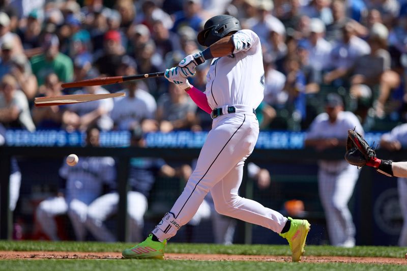 Aug 2, 2023; Seattle, Washington, USA; Seattle Mariners  Julio Rodriguez breaks his bat hitting an RBI single against the Boston Red Sox suring the seventh inning at T-Mobile Park. Mandatory Credit: John Froschauer-USA TODAY Sports