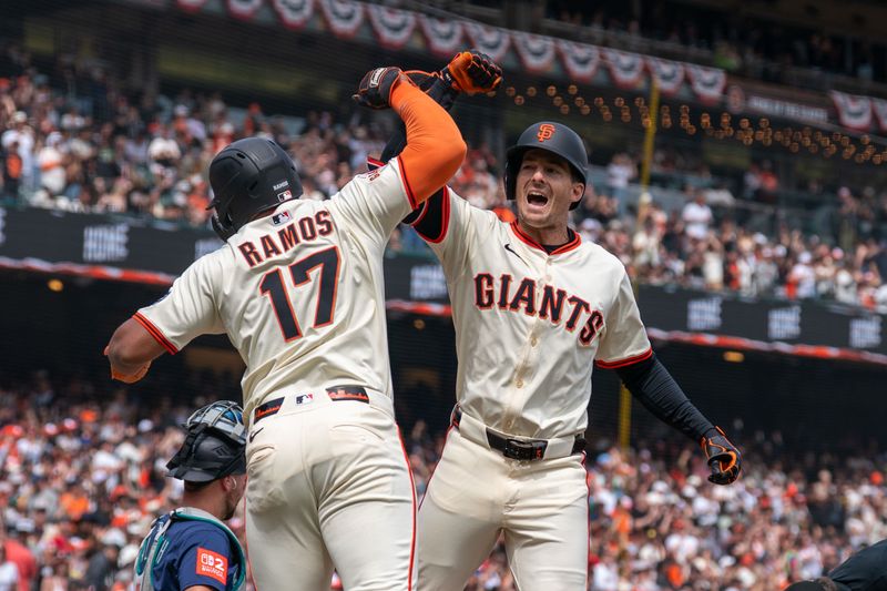 Apr 6, 2025; San Francisco, California, USA; San Francisco Giants designated hitter Heliot Ramos (17) gives for arm bashes toSan Francisco Giants right fielder Mike Yastrzemski (5) for the three run home against the Seattle Mariners during the fourth inning at Oracle Park. Mandatory Credit: Neville E. Guard-Imagn Images