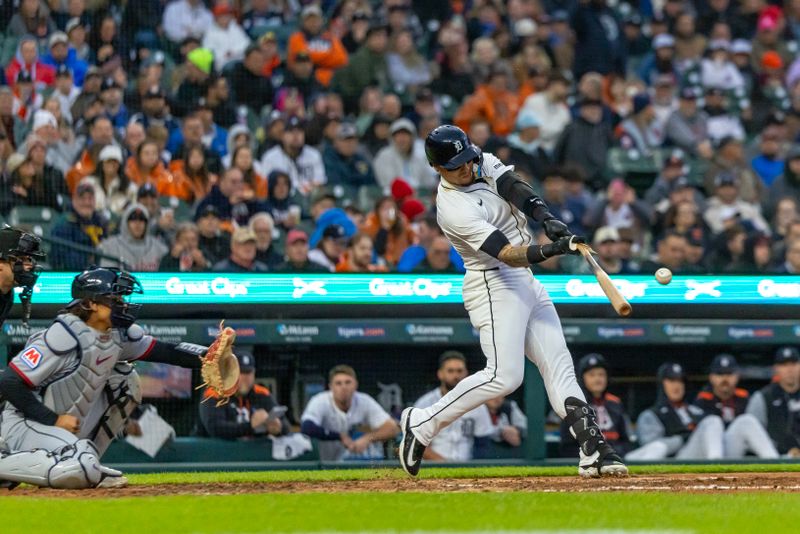 May 22, 2025; Detroit, Michigan, USA; Detroit Tigers outfielder Javier Báez (28) hits a single off of Cleveland Guardians pitcher Tanner Bibee (28) and breaks his bat in the third inning at Comerica Park. Mandatory Credit: David Reginek-Imagn Images