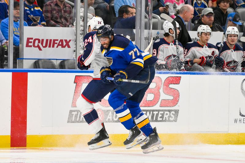 Oct 1, 2024; St. Louis, Missouri, USA;  St. Louis Blues defenseman Pierre-Olivier Joseph (77) checks Columbus Blue Jackets right wing Mathieu Olivier (24) during the first period at Enterprise Center. Mandatory Credit: Jeff Curry-Imagn Images