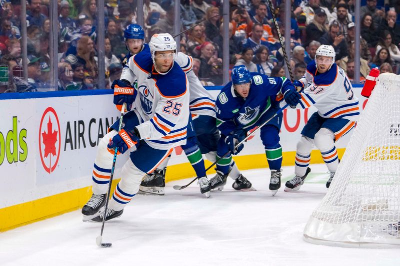 Oct 4, 2024; Vancouver, British Columbia, CAN; Edmonton Oilers defenseman Darnell Nurse (25) handles the puck against the Vancouver Canucks during the third period at Rogers Arena. Mandatory Credit: Bob Frid-Imagn Images