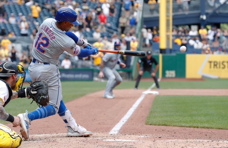 Jul 7, 2024; Pittsburgh, Pennsylvania, USA;  New York Mets shortstop Francisco Lindor (12) hits a game winning two run single against the Pittsburgh Pirates during the ninth inning at PNC Park. The Mets won 3-2. Mandatory Credit: Charles LeClaire-USA TODAY Sports