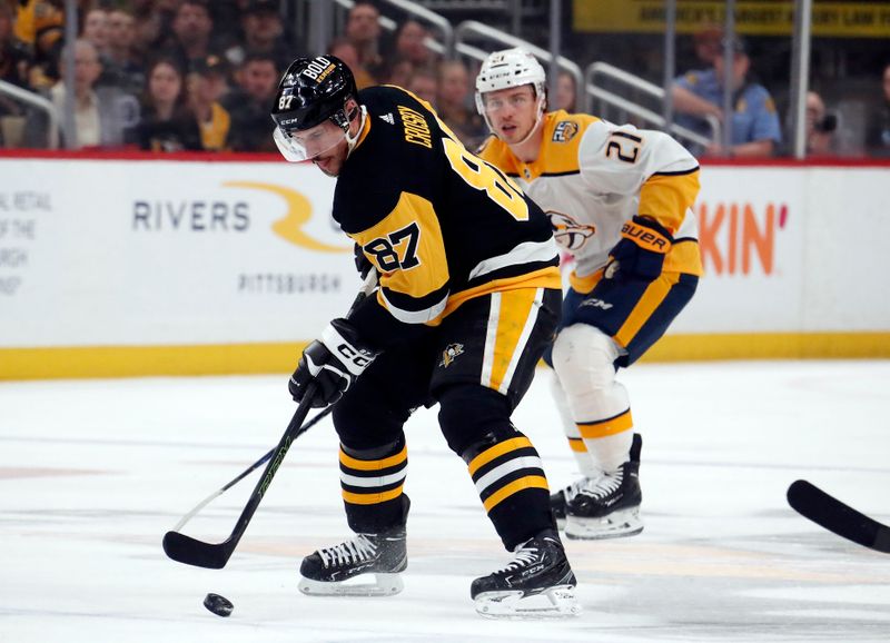 Apr 15, 2024; Pittsburgh, Pennsylvania, USA;  Pittsburgh Penguins center Sidney Crosby (87) skates with the puck against Nashville Predators left wing Anthony Beauvillier (21) during the first period at PPG Paints Arena. Mandatory Credit: Charles LeClaire-USA TODAY Sports