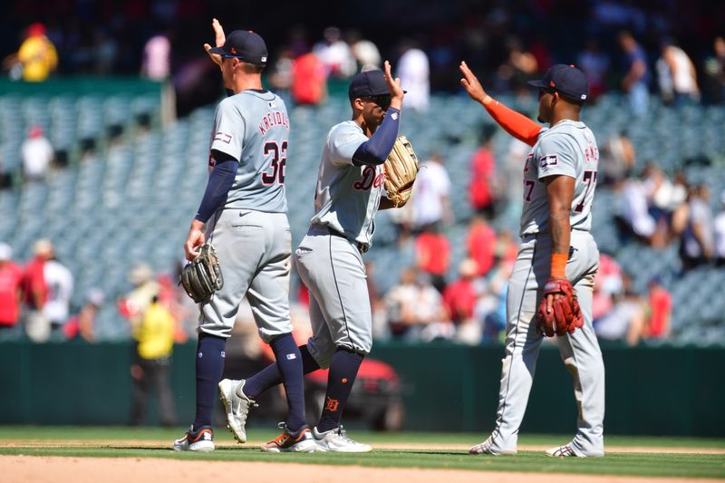 Jun 27, 2024; Anaheim, California, USA; Detroit Tigers shortstop Ryan Kreidler (32) right fielder Wenceel Pérez (46) and second base Andy Ibanez (77) celebrate the victory against the Los Angeles Angels at Angel Stadium. Mandatory Credit: Gary A. Vasquez-USA TODAY Sports