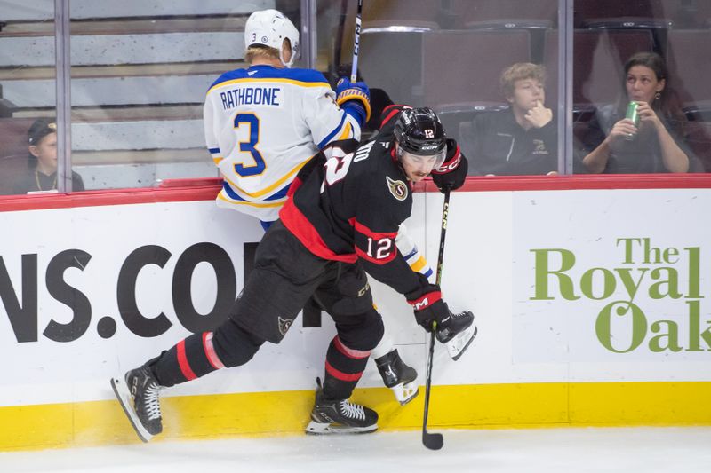 Sep 26, 2024; Ottawa, Ontario, CAN; Buffalo Sabres defenseman Jack Rathbone (3) is checked by Ottawa Senators center Shane Pinto (12) in the third period at the Canadian Tire Centre. Mandatory Credit: Marc DesRosiers-Imagn Images