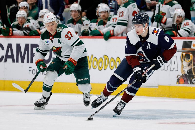 Mar 8, 2024; Denver, Colorado, USA; Colorado Avalanche defenseman Cale Makar (8) controls the puck ahead of Minnesota Wild left wing Kirill Kaprizov (97) in the third period at Ball Arena. Mandatory Credit: Isaiah J. Downing-USA TODAY Sports