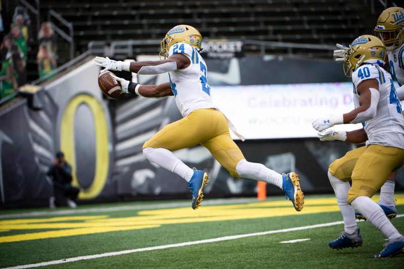 Nov 21, 2020; Eugene, Oregon, USA;  UCLA Bruins defensive back Qwuantrezz Knight (24) recovers a fumble for a touchdown during the first half against the Oregon Ducks at Autzen Stadium. Mandatory Credit: Troy Wayrynen-USA TODAY Sports