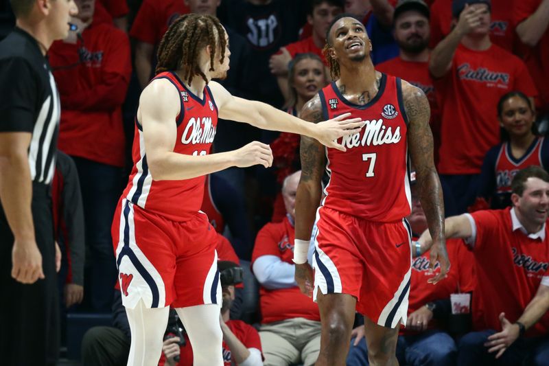 Dec 2, 2023; Oxford, Mississippi, USA; Mississippi Rebels guard Robert Cowherd (13) reacts with guard Allen Flanigan (7) during the first half against the Memphis Tigers at The Sandy and John Black Pavilion at Ole Miss. Mandatory Credit: Petre Thomas-USA TODAY Sports