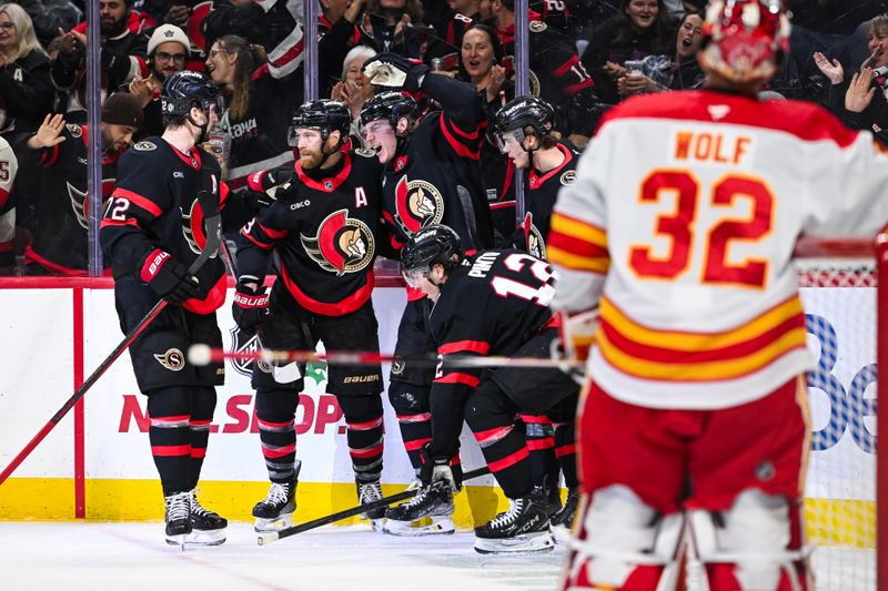 Nov 25, 2024; Ottawa, Ontario, CAN; Ottawa Senators center Adam Gaudette (81) celebrates his goal against Calgary Flames goalie Dustin Wolf (32) with his teammates during the first period at Canadian Tire Centre. Mandatory Credit: David Kirouac-Imagn Images