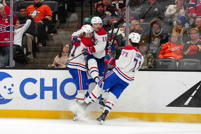 Nov 22, 2023; Anaheim, California, USA; Montreal Canadiens center Alex Newhook (15) celebrates with defenseman Kaiden Guhle (21) and center Jake Evans (71) after scoring a goal against the Anaheim Ducks in the third period at Honda Center. Mandatory Credit: Kirby Lee-USA TODAY Sports