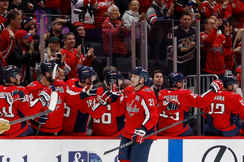 Oct 15, 2024; Washington, District of Columbia, USA; Washington Capitals center Aliaksei Protas (21) celebrates with teammates after scoring a goal against the Vegas Golden Knights in the second period at Capital One Arena. Mandatory Credit: Geoff Burke-Imagn Images