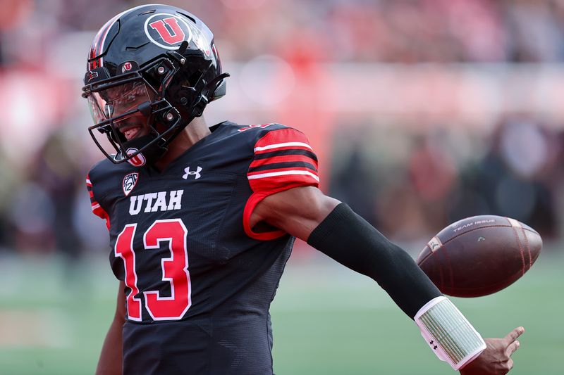 Nov 4, 2023; Salt Lake City, Utah, USA; Utah Utes quarterback Nate Johnson (13) celebrates a touchdown against the Arizona State Sun Devils in the fourth quarter at Rice-Eccles Stadium. Mandatory Credit: Rob Gray-USA TODAY Sports