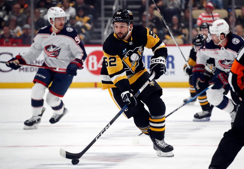 Mar 5, 2024; Pittsburgh, Pennsylvania, USA; Pittsburgh Penguins right wing Emil Bemstrom (52) skates with the puck against the Columbus Blue Jackets during the first period at PPG Paints Arena. Mandatory Credit: Charles LeClaire-USA TODAY Sports