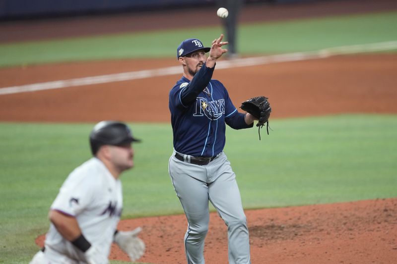 Aug 30, 2023; Miami, Florida, USA; Tampa Bay Rays relief pitcher Shawn Armstrong (64) throws out Miami Marlins third baseman Jake Burger (36) in the ninth inning at loanDepot Park. Mandatory Credit: Jim Rassol-USA TODAY Sports