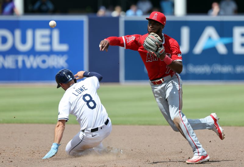 Apr 10, 2025; Tampa, Fl, USA;  Los Angeles Angels shortstop Tim Anderson (77) forces out Tampa Bay Rays second base Brandon Lowe (8) and throws the ball to first base for a double play during the sixth inning at George M. Steinbrenner Field. Mandatory Credit: Kim Klement Neitzel-Imagn Images