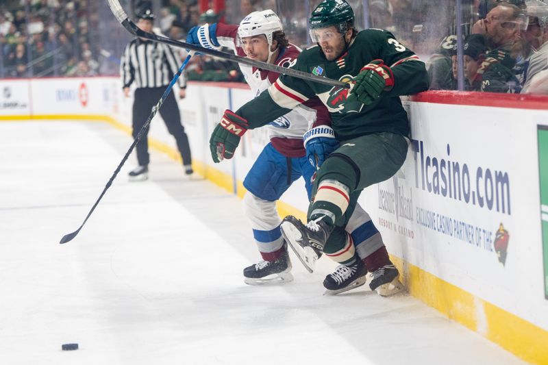 Mar 11, 2025; Saint Paul, Minnesota, USA; Colorado Avalanche defenseman Samuel Girard (49) and Minnesota Wild right wing Ryan Hartman (38) collide along the boards in the first period at Xcel Energy Center. Mandatory Credit: Matt Blewett-Imagn Images