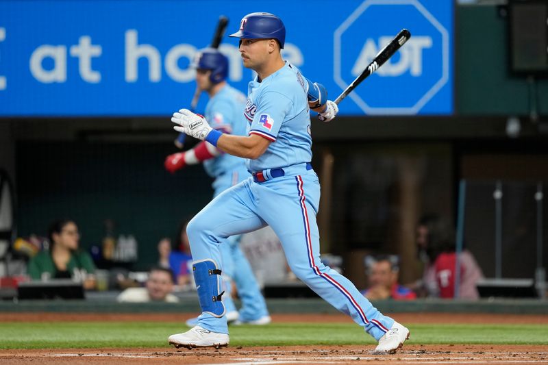 Aug 20, 2023; Arlington, Texas, USA; Texas Rangers first baseman Nathaniel Lowe (30) singles against the Milwaukee Brewers during the first inning at Globe Life Field. Mandatory Credit: Jim Cowsert-USA TODAY Sports